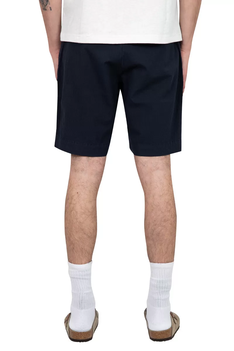 Universal Works. Blue pleated track short